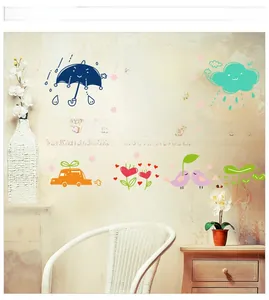 Detailed view of colorful sun, cloud, and car wall decals in a warm kid room setting