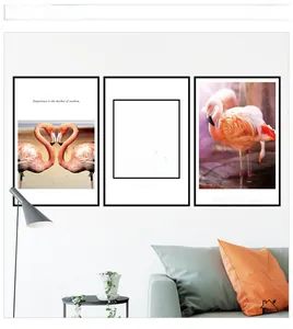 Minimalist flamingo wall art set with Stockholm typography over a grey sofa