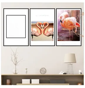 Three-piece modern flamingo wall art set with black frames in a stylish living room