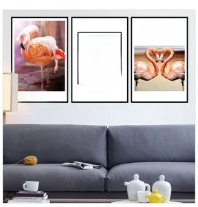 Modern flamingo wall art set with black frames above a grey sofa for home decor