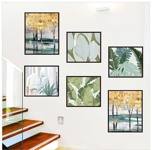 Detail view of 6-piece botanical and autumn landscape framed wall art set on staircase wall