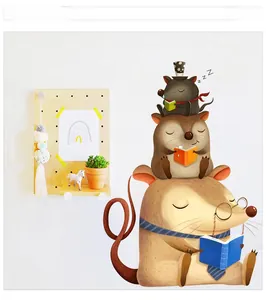 Detail view of cartoon mice reading stickers on white wall with pegboard decor