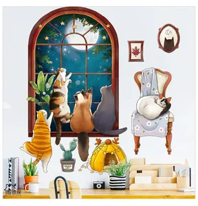 Detailed view of cartoon cat wall stickers featuring night sky windows on a white wall