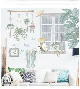 Detailed close-up of decorative wall stickers featuring cats and green potted plants