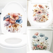 Detail of floral watercolor toilet lid stickers with pink and blue blossoms on white ceramic