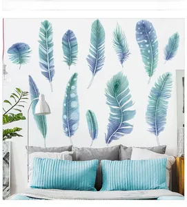 Detail view of 12 blue watercolor feather wall stickers on a white bedroom wall