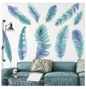 Close-up of blue feather wall stickers with gradient textures on a modern white wall