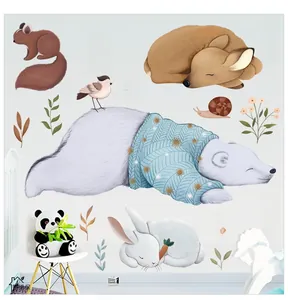 Detail view of cartoon polar bear and deer wall stickers in a cozy nursery room setting