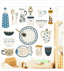 Detail of kitchen wall stickers with hand-drawn teapot and dish patterns on a white wall