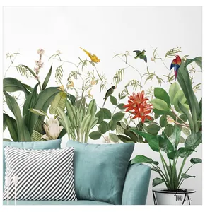 Detailed close-up of tropical palm leaves and parrot wall sticker on a white wall