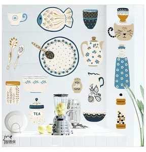 Detail of hand-drawn kitchen wall stickers with blue teapots and fish on white brick