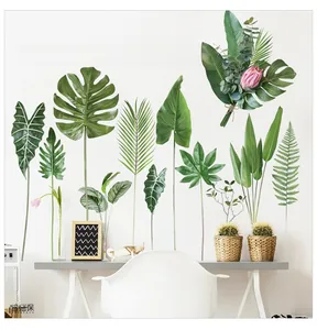 Detail of tropical monstera leaf wall decals on a white wall in a minimalist Nordic room