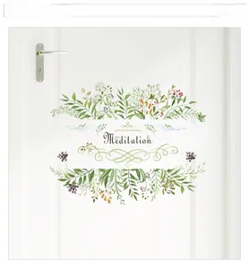 Detail view of Meditation wall decal with green leaves and berries on a white door