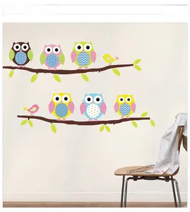 Detail view of colorful cartoon owl wall stickers on branches for nursery wall decor