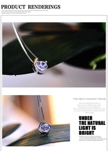Macro detail of round-cut zircon pendant with silver box chain on natural leaves
