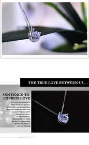 Macro shot of silver box chain and brilliant round cut zircon pendant with claw setting