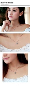 Silver moon-curved necklace and stud earrings set with sparkling zircon on a model