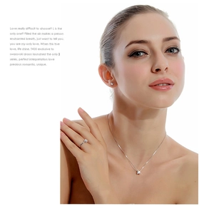 Model wearing a three-piece jewelry set with necklaces, rings and stud earrings