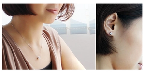 Detail view of elegant silver-tone necklace and cubic zirconia stud earrings set on a model