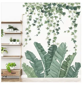 Detail view of green banana leaves and hanging vine wall stickers in a cozy living room