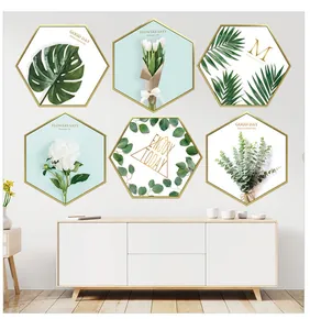 Detail view of six-piece hexagonal wall art with botanical prints and minimalist gold frames