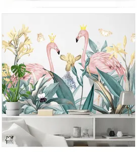 Détail de stickers muraux flamants et feuilles tropicales sur un buffet blanc