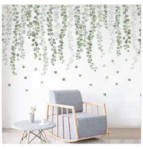 Modern living room decor featuring green eucalyptus wall decals hanging over a grey rocking chair