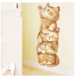 Close-up of four cute cartoon orange cats climbing a ladder wall decal on a yellow wall