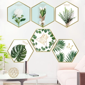 Set of six hexagonal wall art pieces featuring golden frames and botanical flower designs