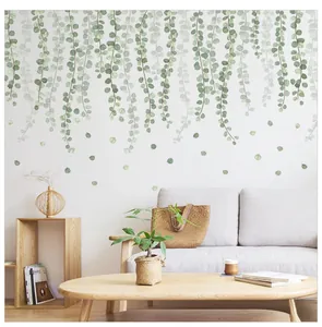 Detail of hanging green eucalyptus leaves wall decal in a Nordic style living room