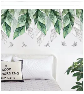 Macro detail of watercolor tropical leaf wall decal with butterfly and love quote