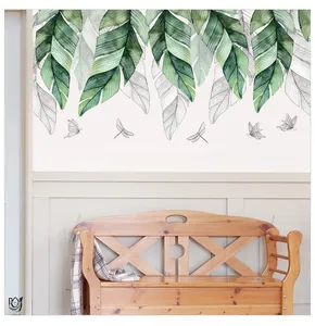 Detail of banana leaf wall sticker with motivational quote and flying butterflies