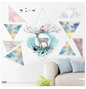 Detail of Nordic elk wall sticker with marble triangles and sun over a cozy sofa decor