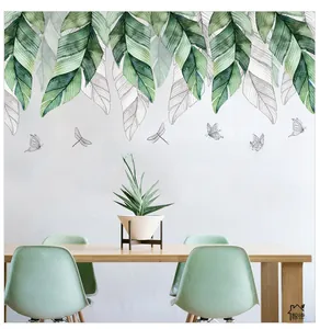 Detail view of tropical leaf wall stickers and inspirational quote in a dining room setting