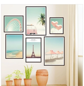 Gallery wall set with 6 framed pink landscape posters featuring Eiffel Tower and beach