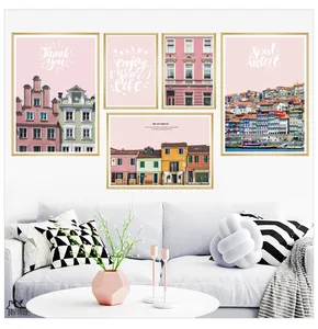 Detail of five-piece modern wall art set with gold frames and pink European architecture