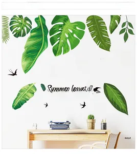 Detail of tropical monstera leaf wall stickers with summer text in a cozy home office setup