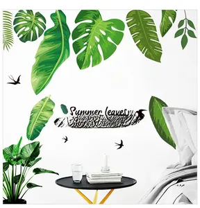 Detail of tropical monstera leaf wall stickers with birds on white bedroom wall