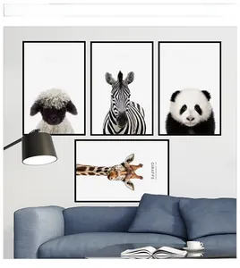 Detail view of four minimalist black and white animal art prints in a modern living room