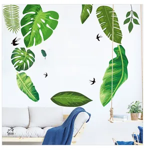 Detail of tropical monstera leaves wall stickers and swallow silhouettes in a Nordic living room