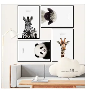 Detail view of four minimalist animal wall art frames in a modern Nordic living room
