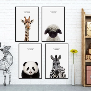 Modern animal portrait wall art set with minimalist black frames on a white brick wall