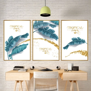 Three-piece set of tropical banana leaf wall art with gold frames in modern minimalist style