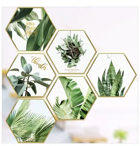 Detail of hexagonal plant wall art stickers with gold frames and green leaves