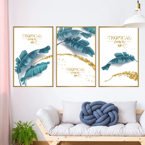 Three-piece tropical banana leaf wall art set with gold frames for modern home decor