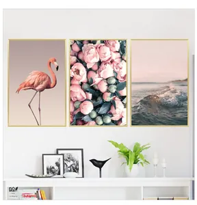 Detailed set of three pink flamingo and peony wall art prints in elegant gold frames