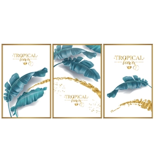 Three-piece set of tropical banana leaf wall art with minimal gold frames and blue tones
