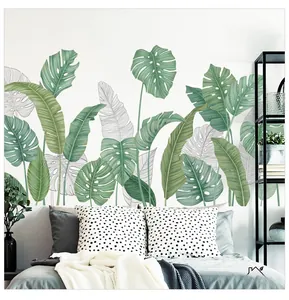 Detail of tropical Monstera leaf wall decals in a modern Scandinavian bedroom setting