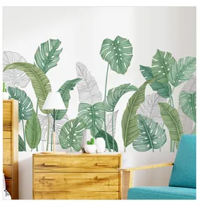 Detail of tropical monstera leaf wall stickers in a minimalist living room setting