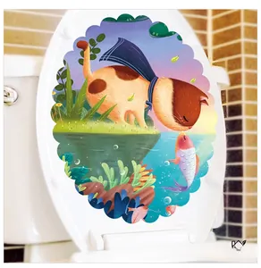 Detail showing a cartoon cat and fish waterproof sticker applied to a white toilet lid